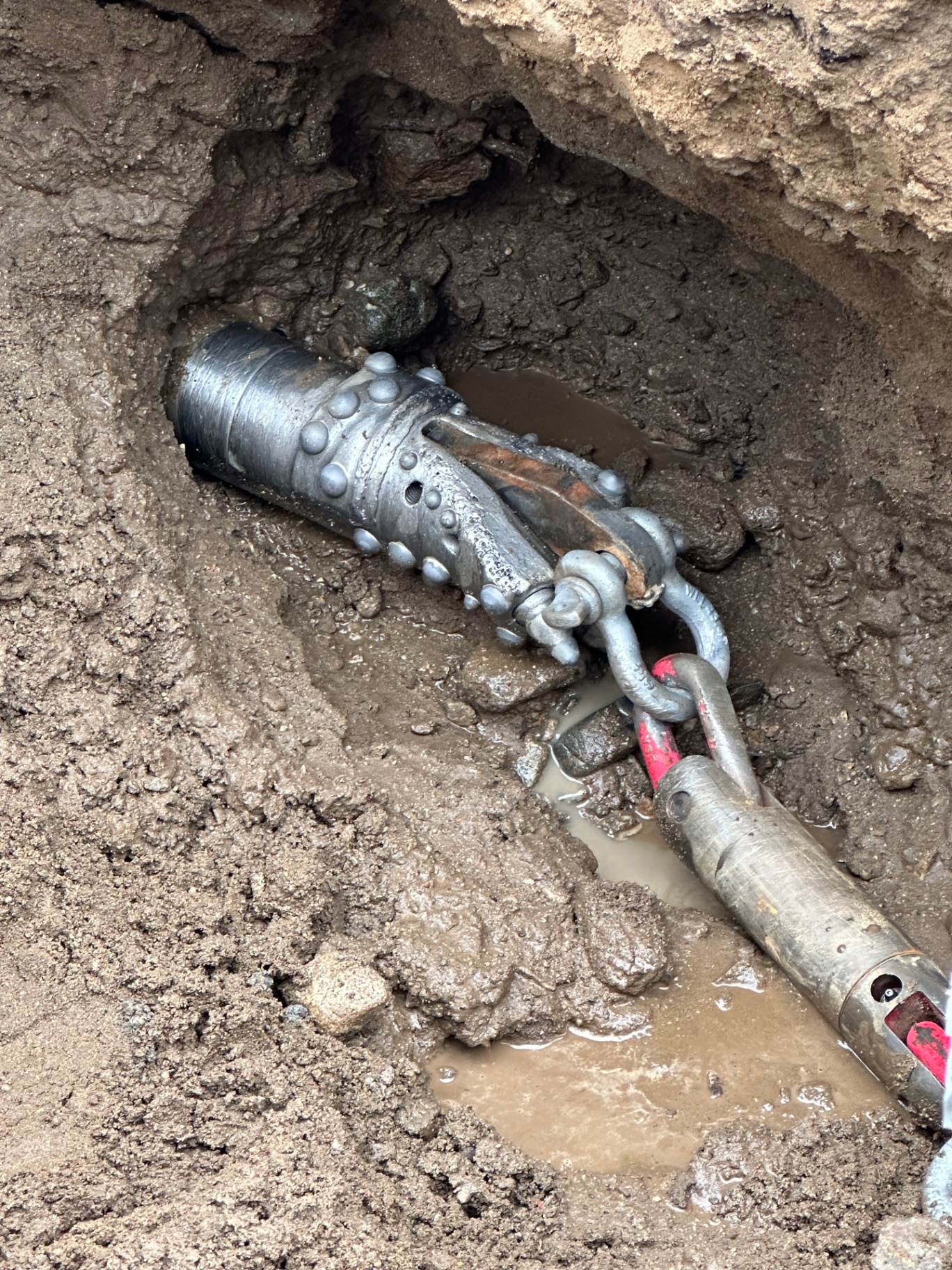Rock reamer pulling product pipe